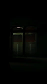 Close-up of a haunted mansion’s creaky door slightly ajar, glowing with ominous light.