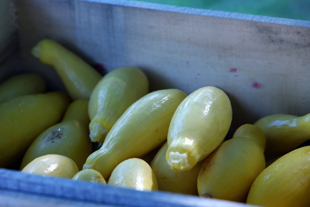 a container filled with yellow fruit sitting on top of a table
