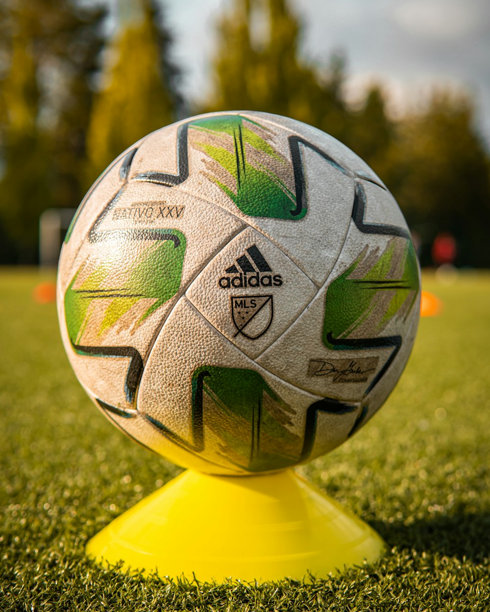 a soccer ball sitting on top of a yellow stand