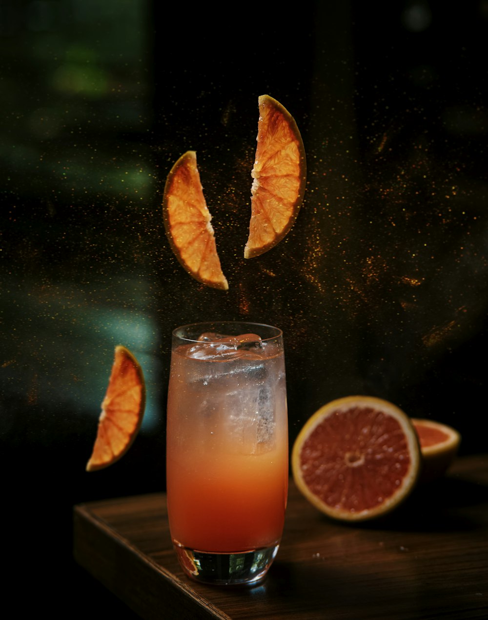 grapefruit and blood orange juice being poured into a glass