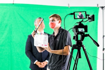 a man holding a camera and a video camera