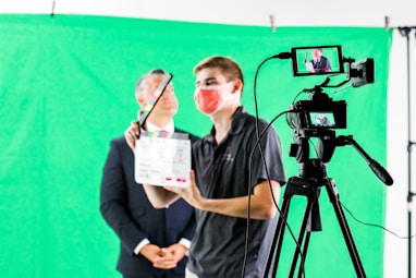 a man holding a camera and a video camera
