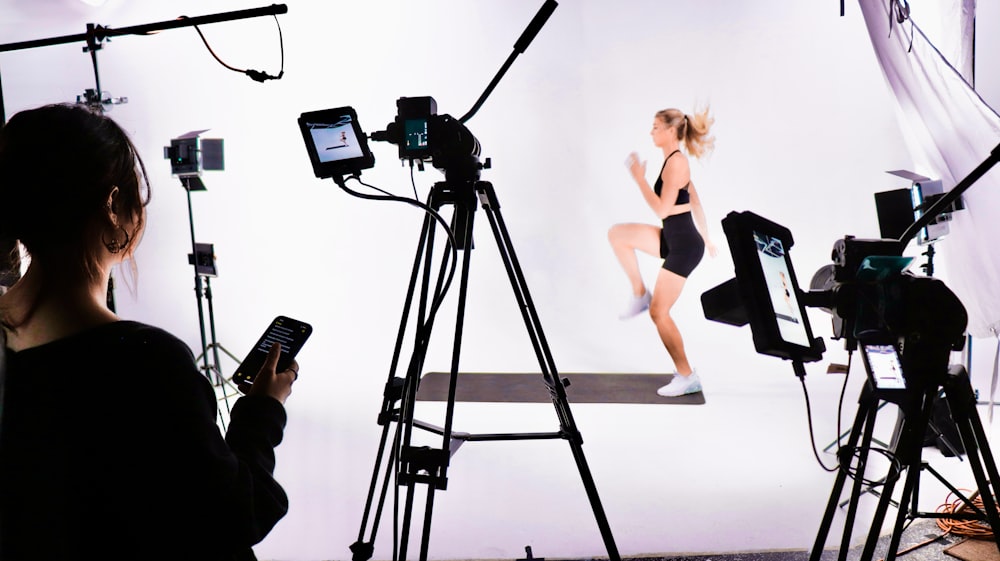 a woman standing in front of a camera