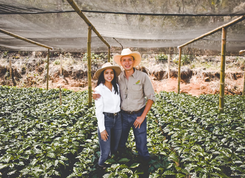 a man and a woman standing in a field