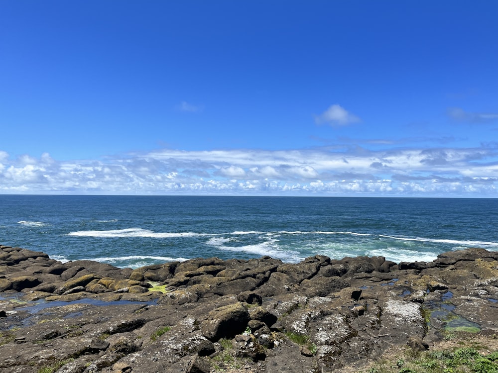 a view of the ocean from a rocky shore