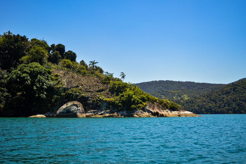 a body of water with a small island in the middle of it