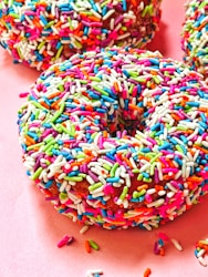 Donuts with sprinkles pink background