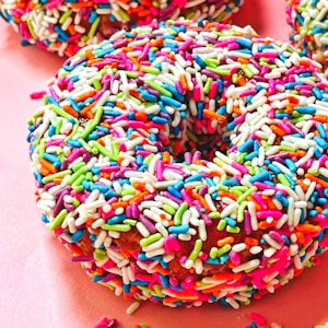 Donuts with sprinkles pink background