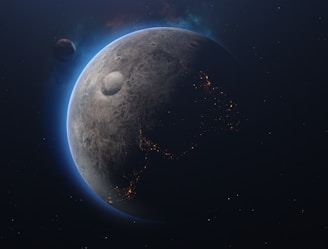 A celestial scene featuring a planet with a textured, cratered surface. The planet's edges are illuminated with a blue glow, highlighting a partial view of illuminated patterns resembling city lights. Another smaller celestial body is visible at a distance, adding depth to the space scene.