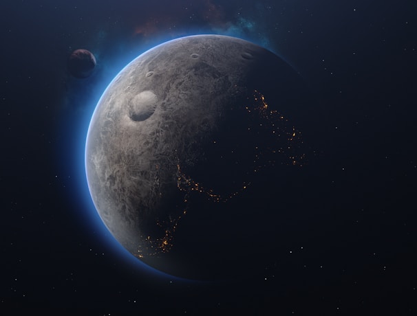 A celestial scene featuring a planet with a textured, cratered surface. The planet's edges are illuminated with a blue glow, highlighting a partial view of illuminated patterns resembling city lights. Another smaller celestial body is visible at a distance, adding depth to the space scene.
