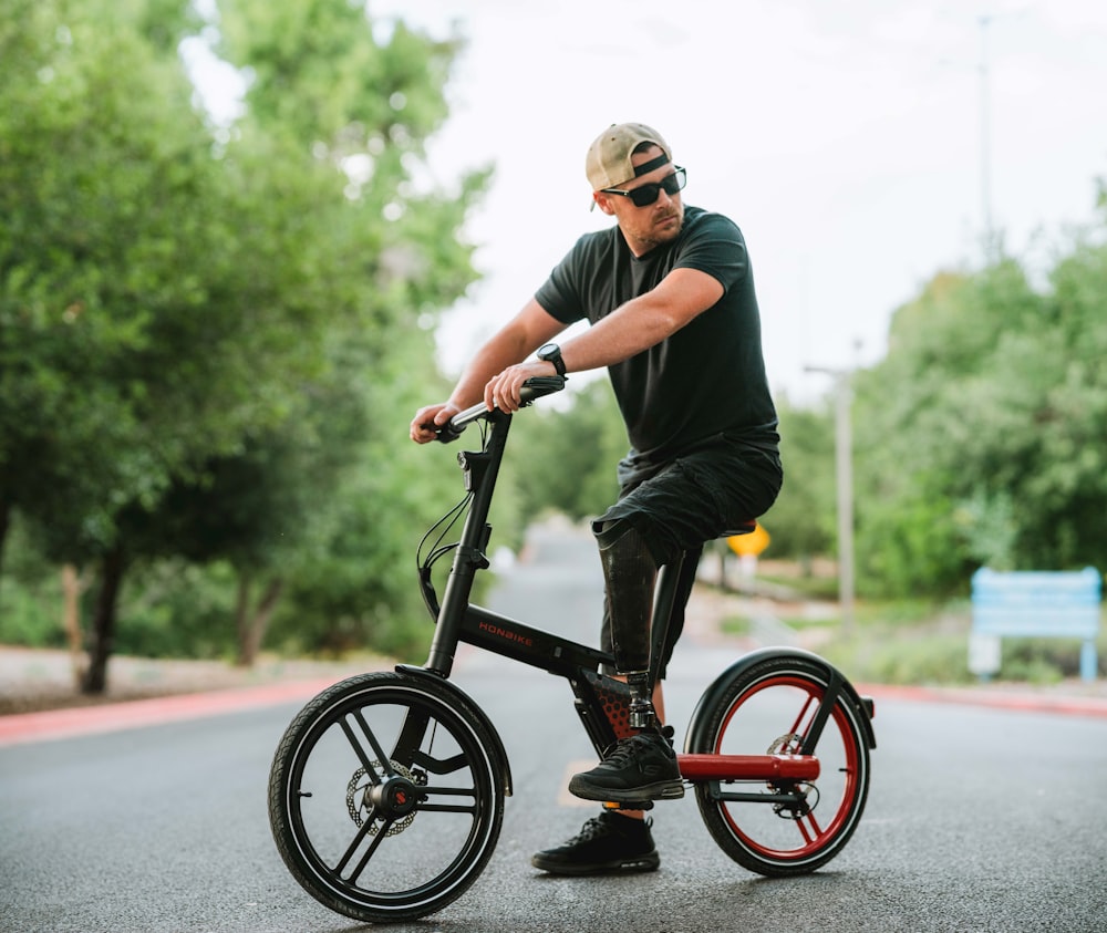 a man riding a bike down the middle of a street