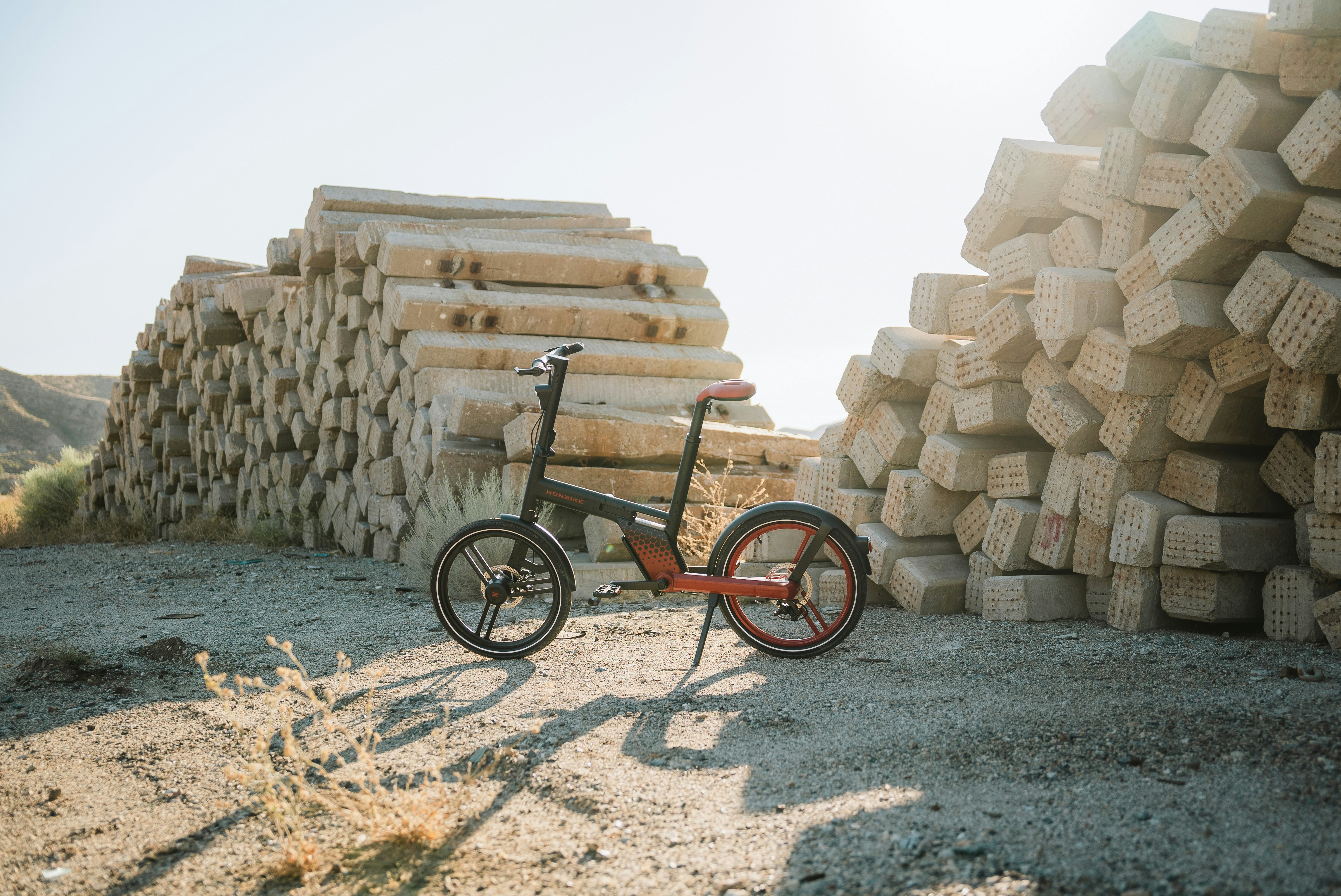 a bicycle parked next to a pile of logs