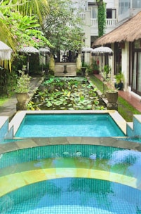a pool with a waterfall in the middle of it