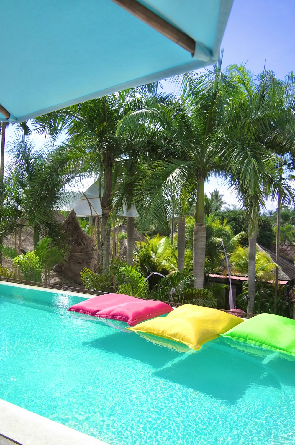 a swimming pool with a row of colorful umbrellas