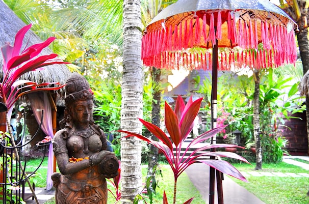 a statue of a woman holding a baby in a garden