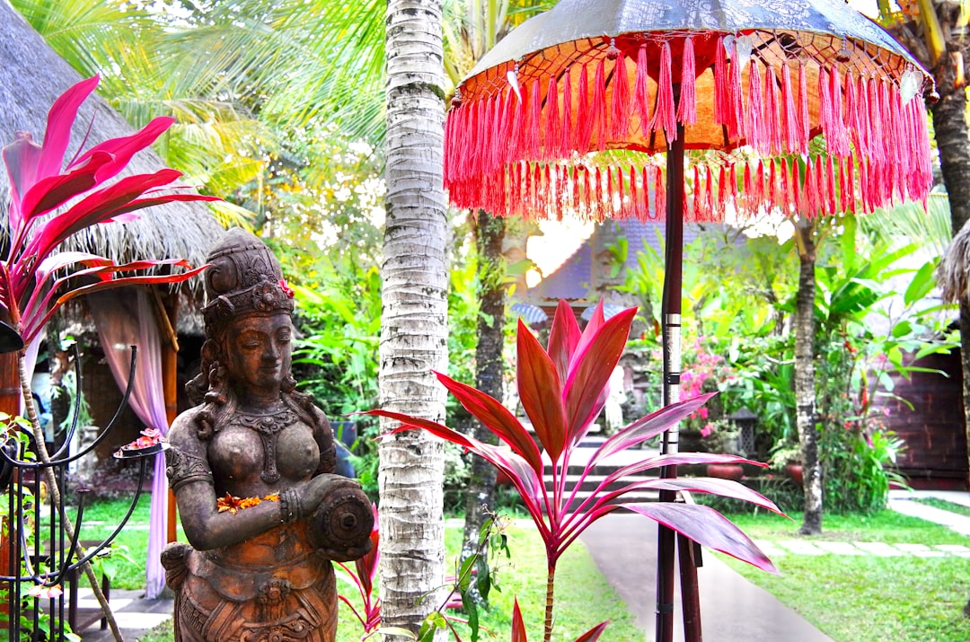a statue of a woman holding a baby in a garden, Mansion Bali Resort by Kate Branch
