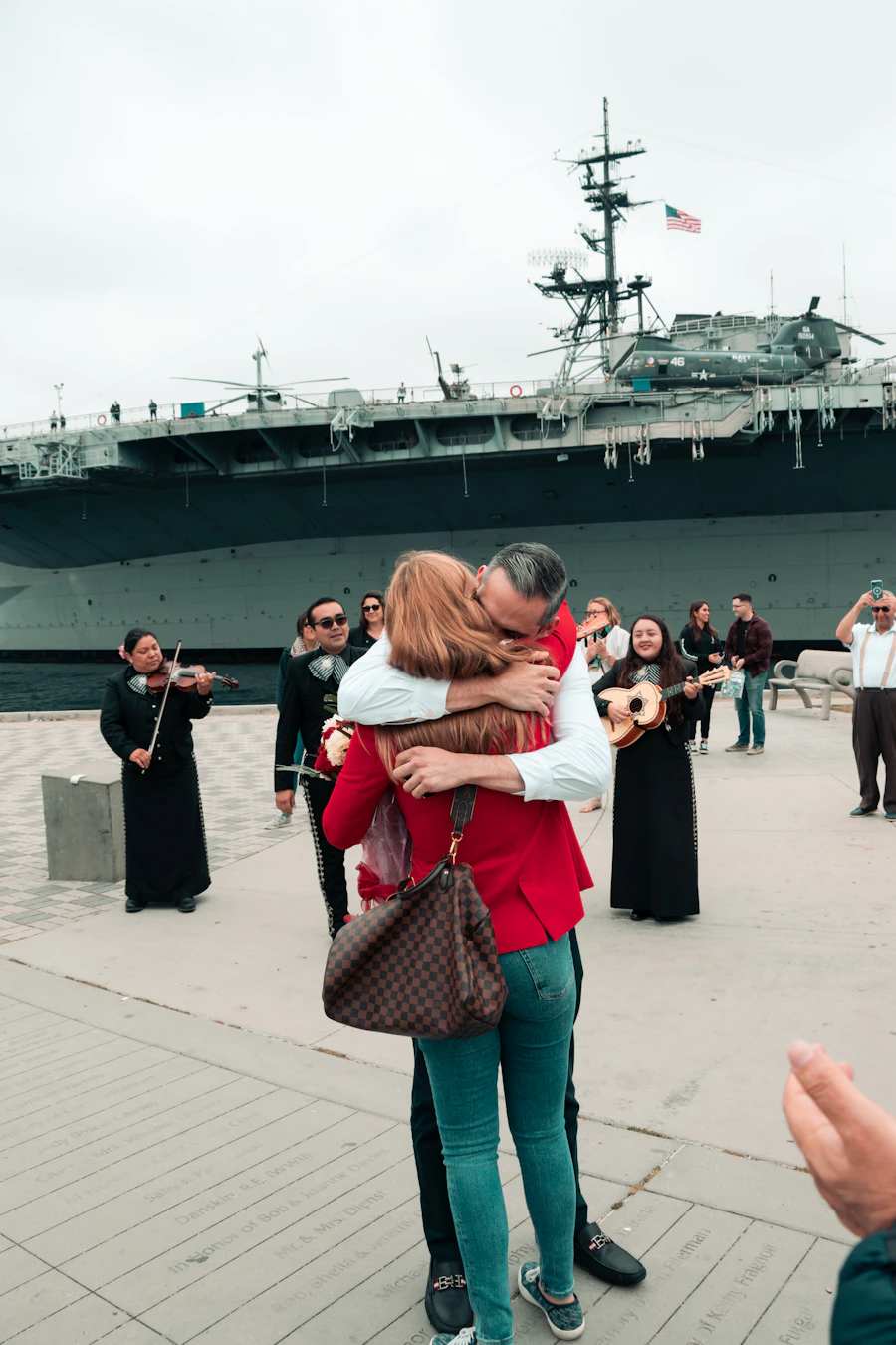 A sailor and his family embrace at a homecoming