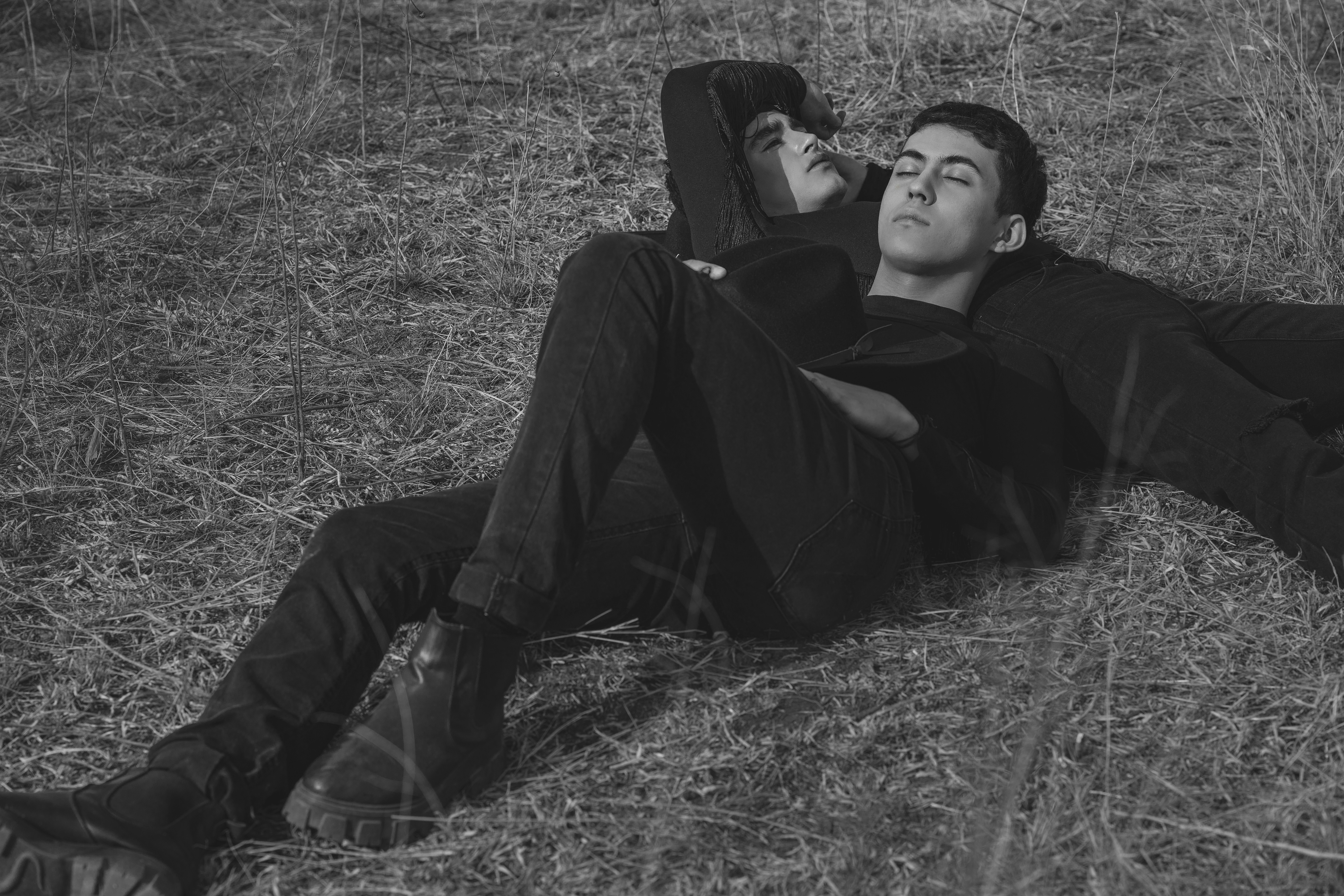 a black and white photo of a man laying on the ground