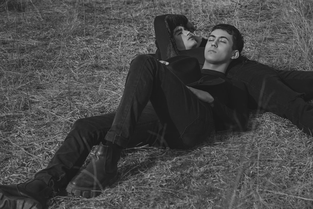 a black and white photo of a man laying on the ground