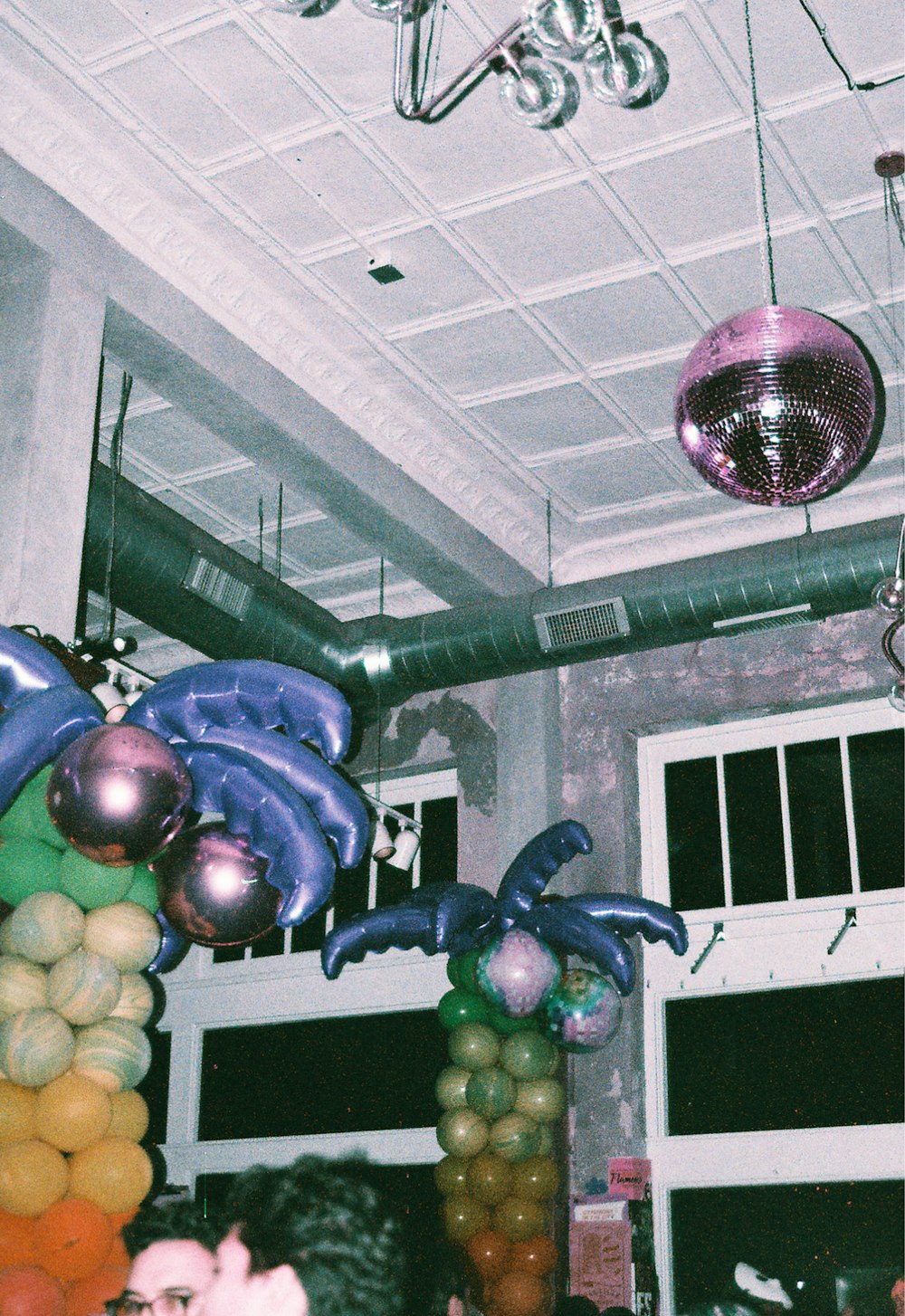 a group of people in a room with balloons