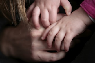 A serene family moment showing hands gently holding each other, symbolizing healing and connection.