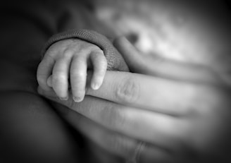 a close up of a person holding a baby