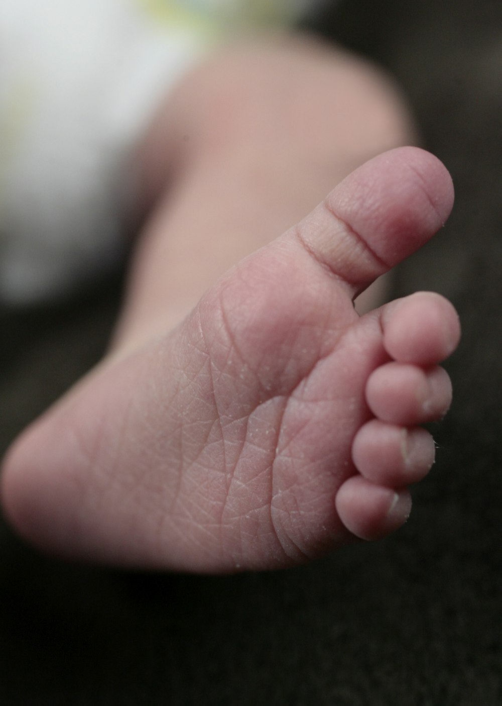 a close up of a baby's bare foot