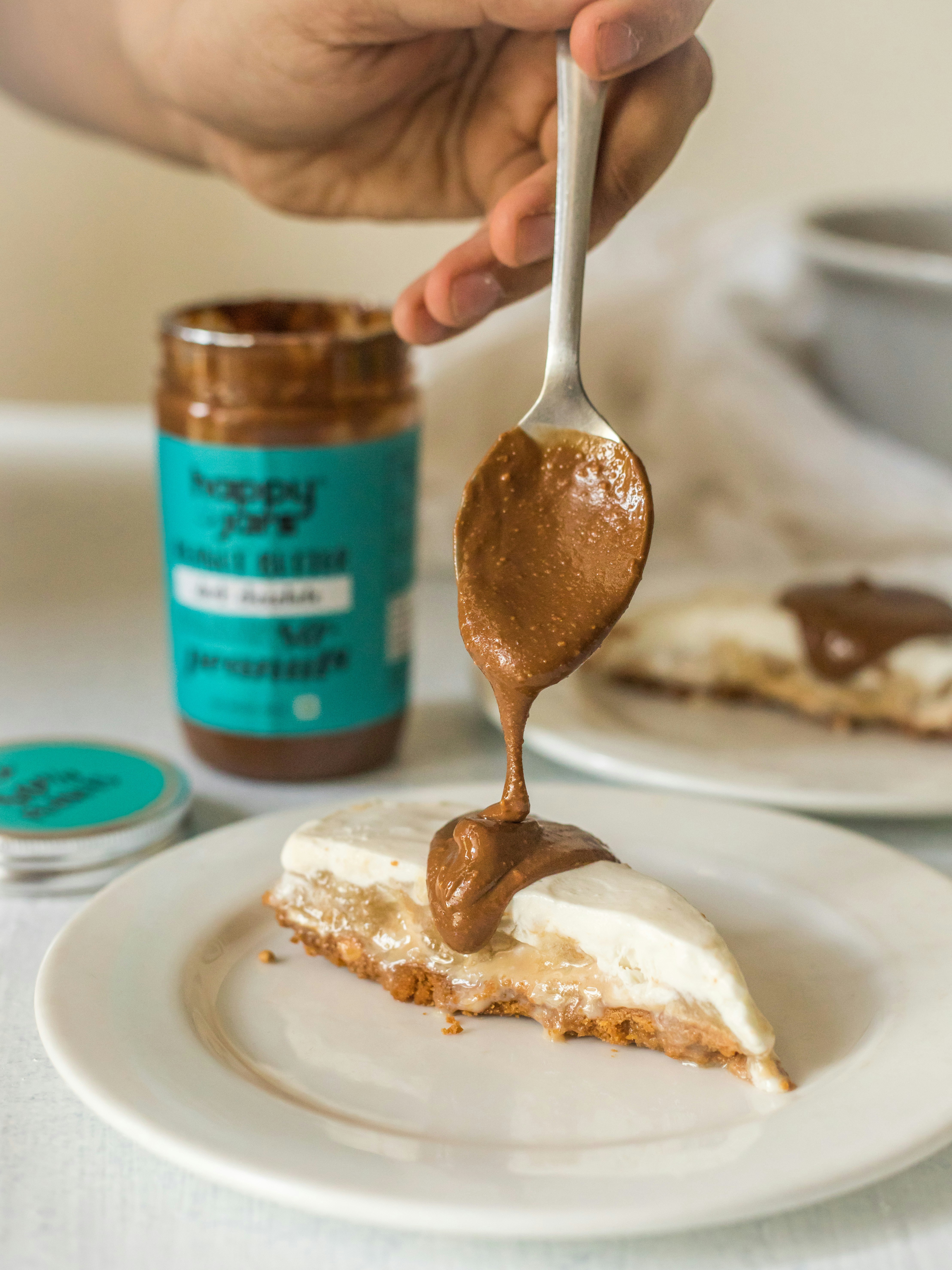 a person holding a spoon with a piece of cake on it