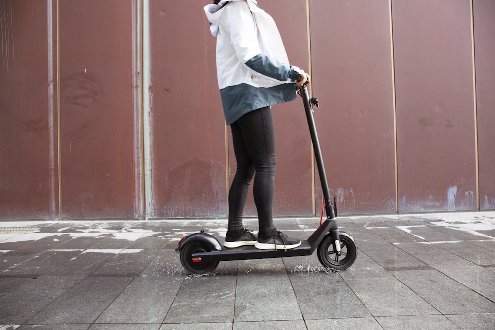 a person riding a scooter on a city street