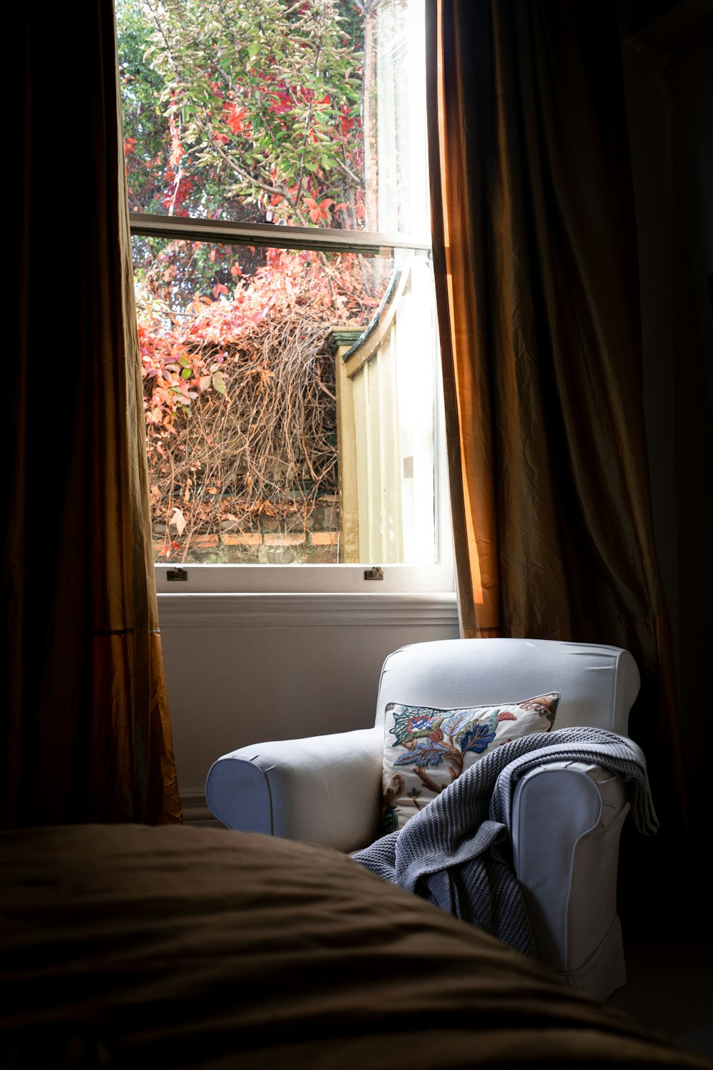 a white chair sitting in front of a window