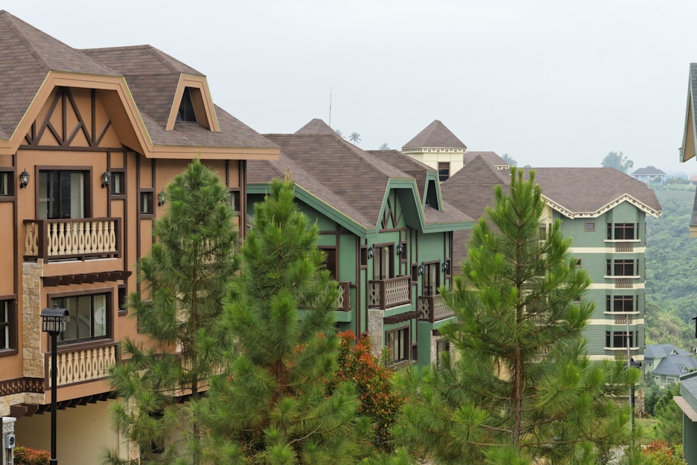 a row of houses with trees in front of them