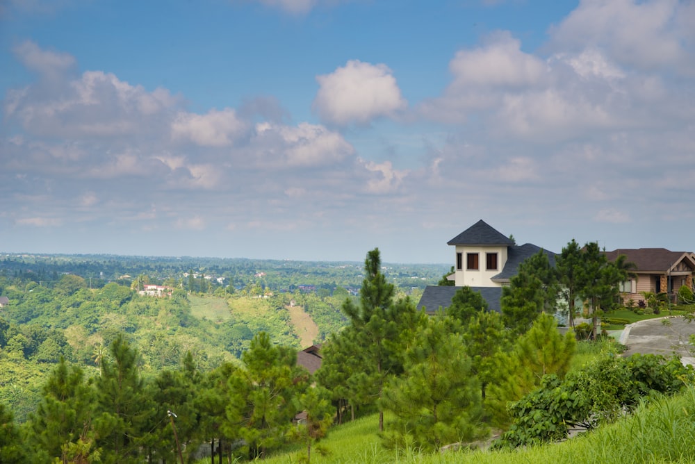 a house on top of a hill surrounded by trees