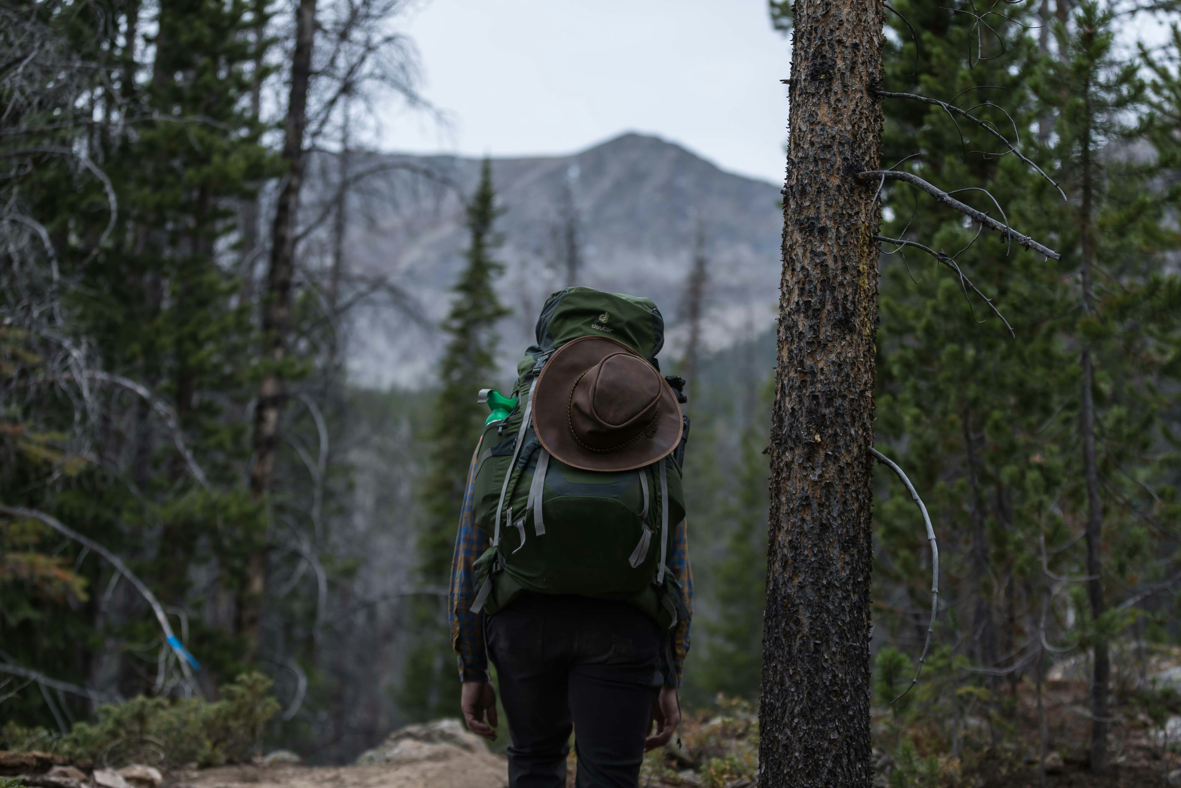 hiker with heavy pack mountain ridge in distance