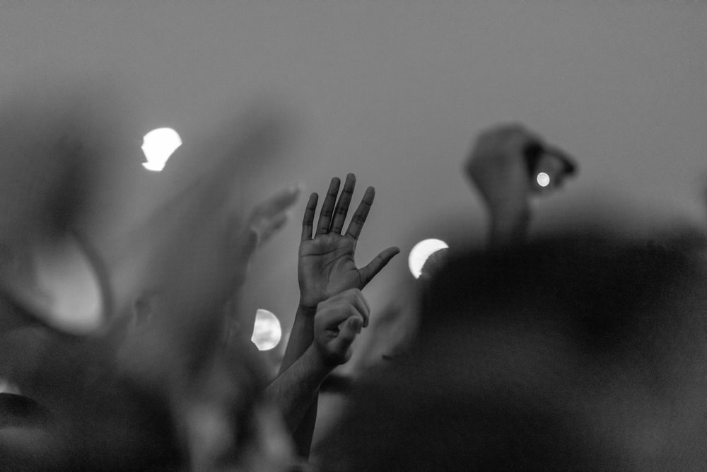 a group of people raising their hands in the air