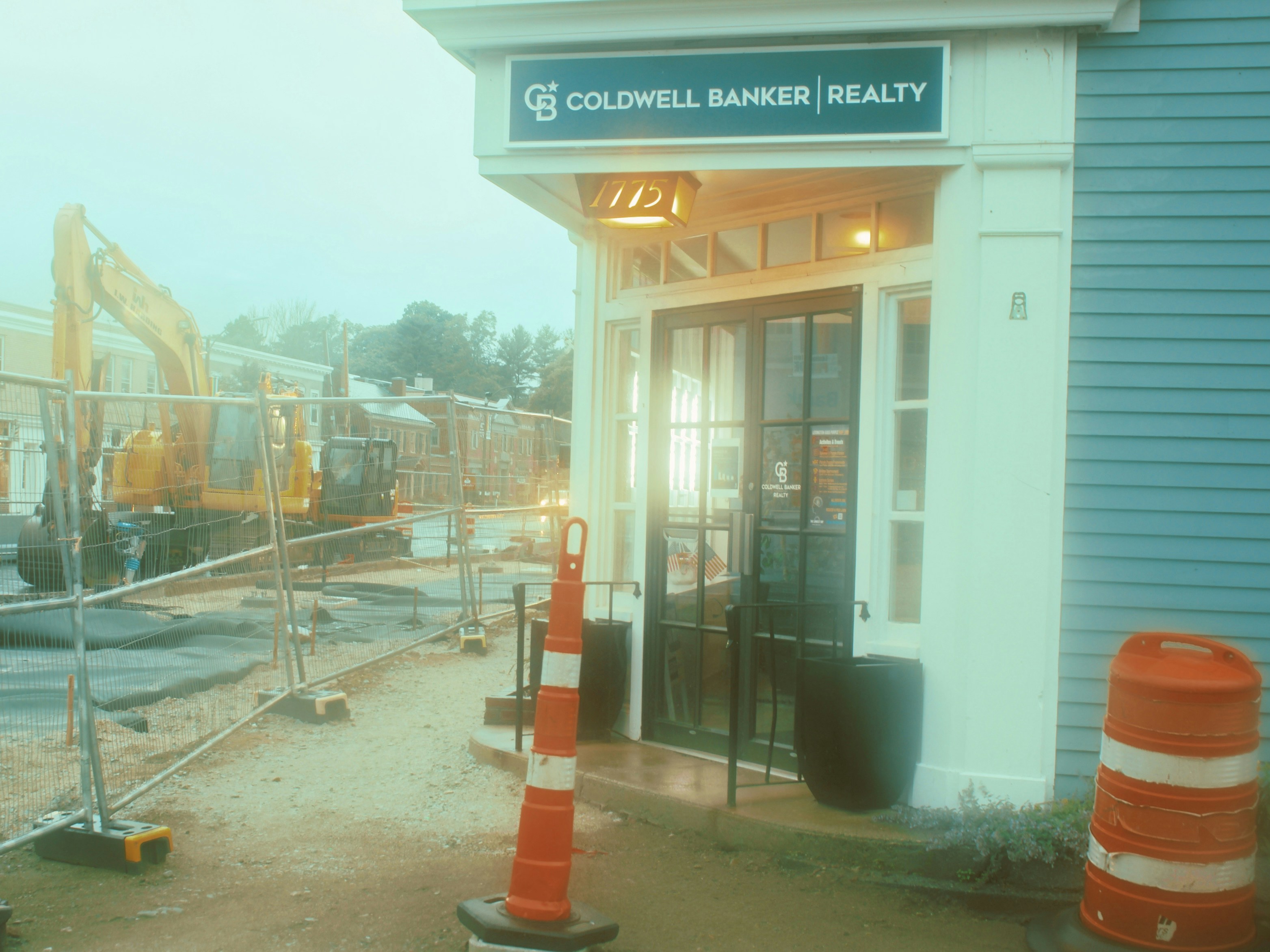 Coldwell Banker realty office building next to a construction site.