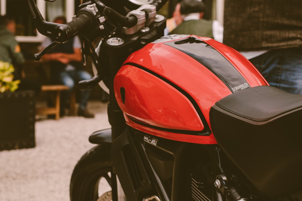 a red and black motorcycle parked on a street