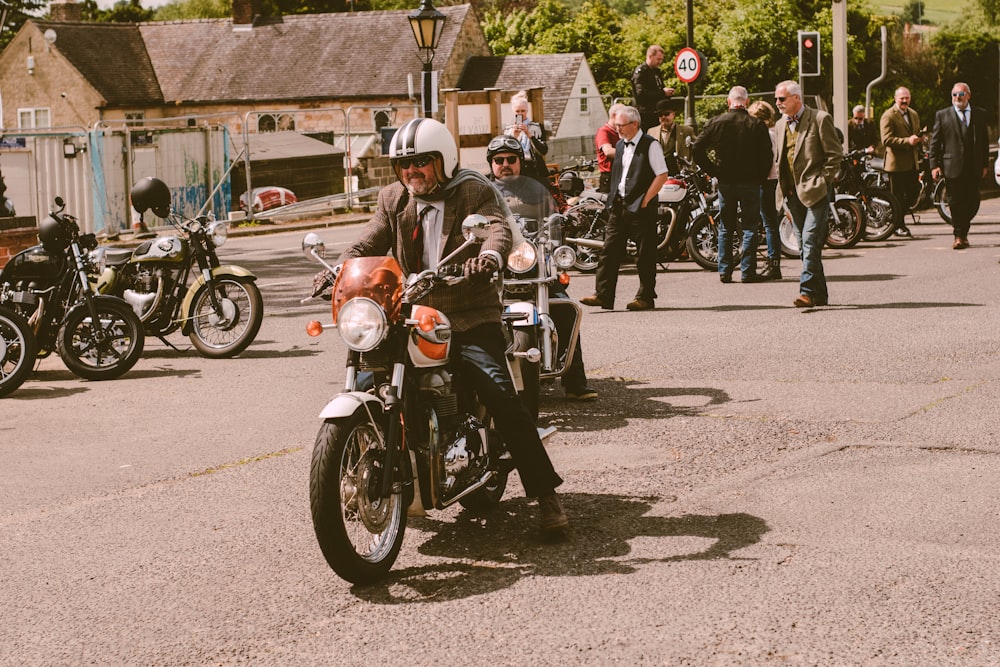 a man riding a motorcycle down a street