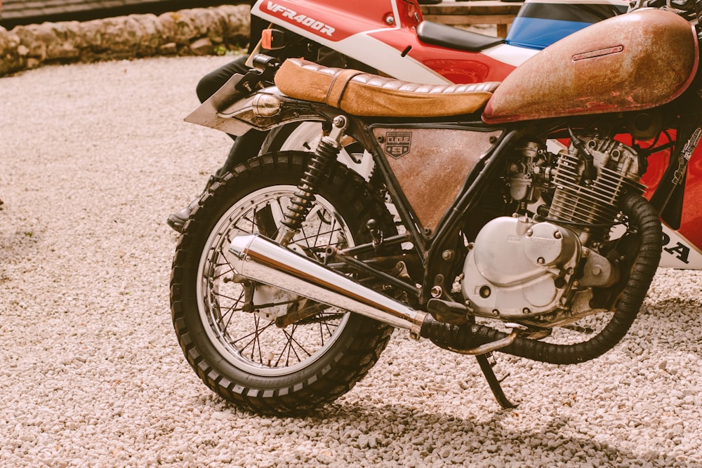 a motorcycle is parked on a gravel road