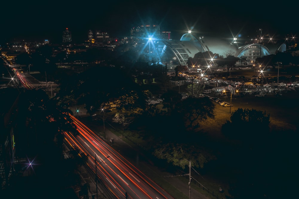 a city skyline at night with a ferris wheel in the background