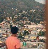 a person standing on a balcony looking at a city