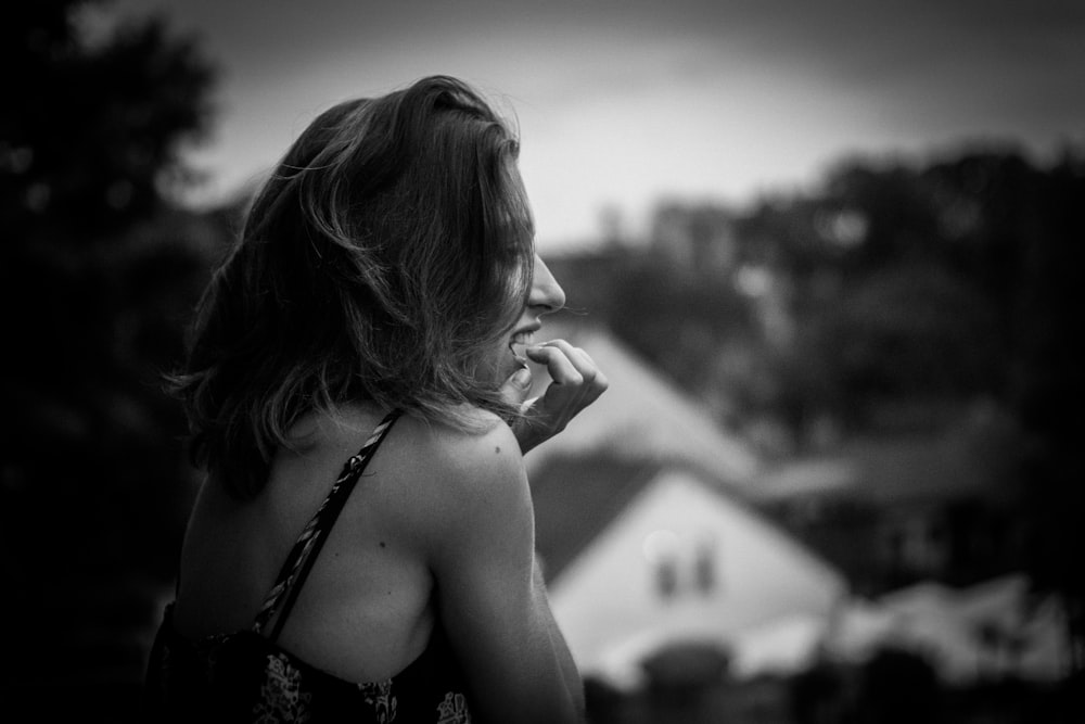 a woman in a black and white photo talking on a cell phone