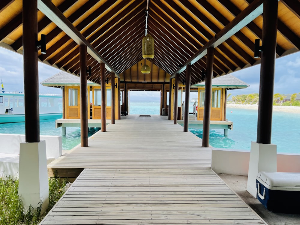 a wooden walkway leading to a dock on a tropical island