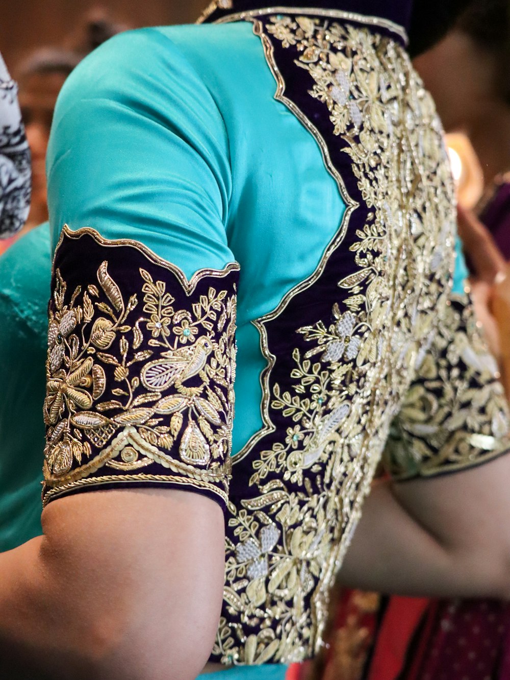 a close up of a woman wearing a blue blouse