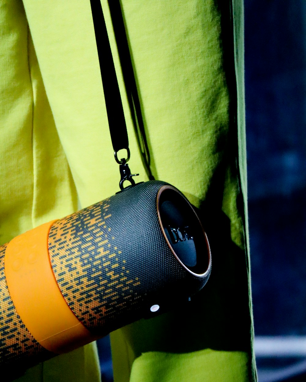 a woman is holding a bluetooth speaker