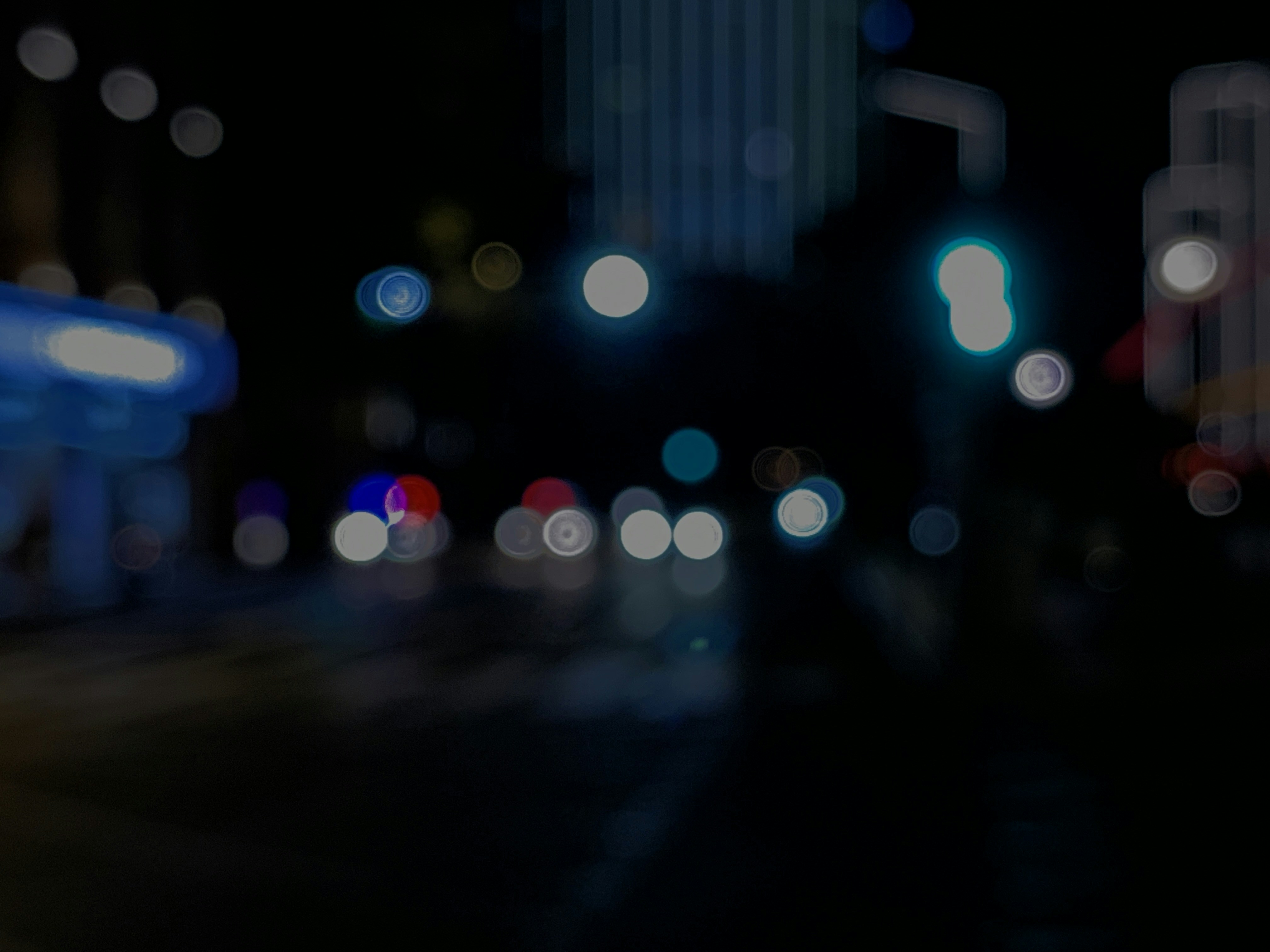 a blurry photo of a city street at night