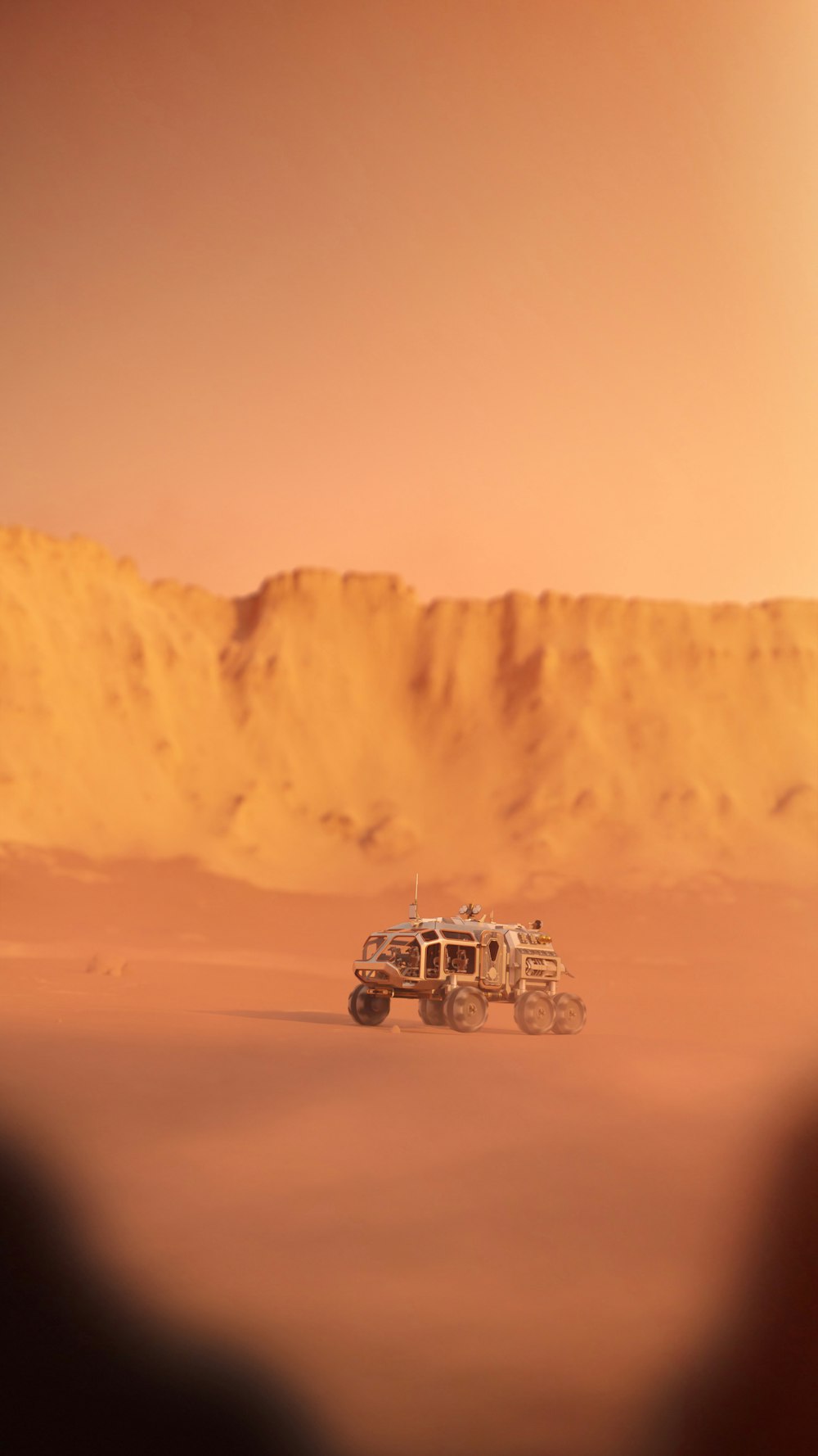 a vehicle driving through the desert on a sunny day