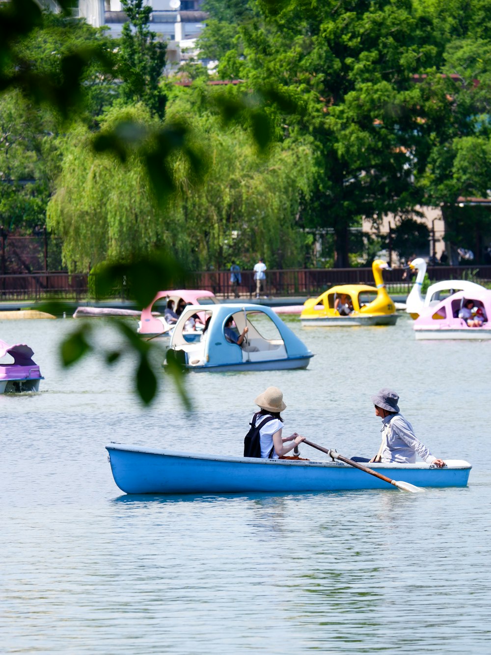 a couple of people in a blue boat on a lake