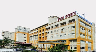 a yellow and white building with a red sign on top of it