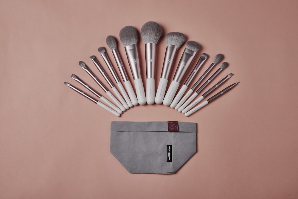 a set of makeup brushes sitting on top of a pouch