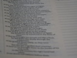 The image features a close-up view of a page from a religious text, possibly a Bible, displaying a number of verses arranged in a column. The text appears to be discussing historical events and divine actions.